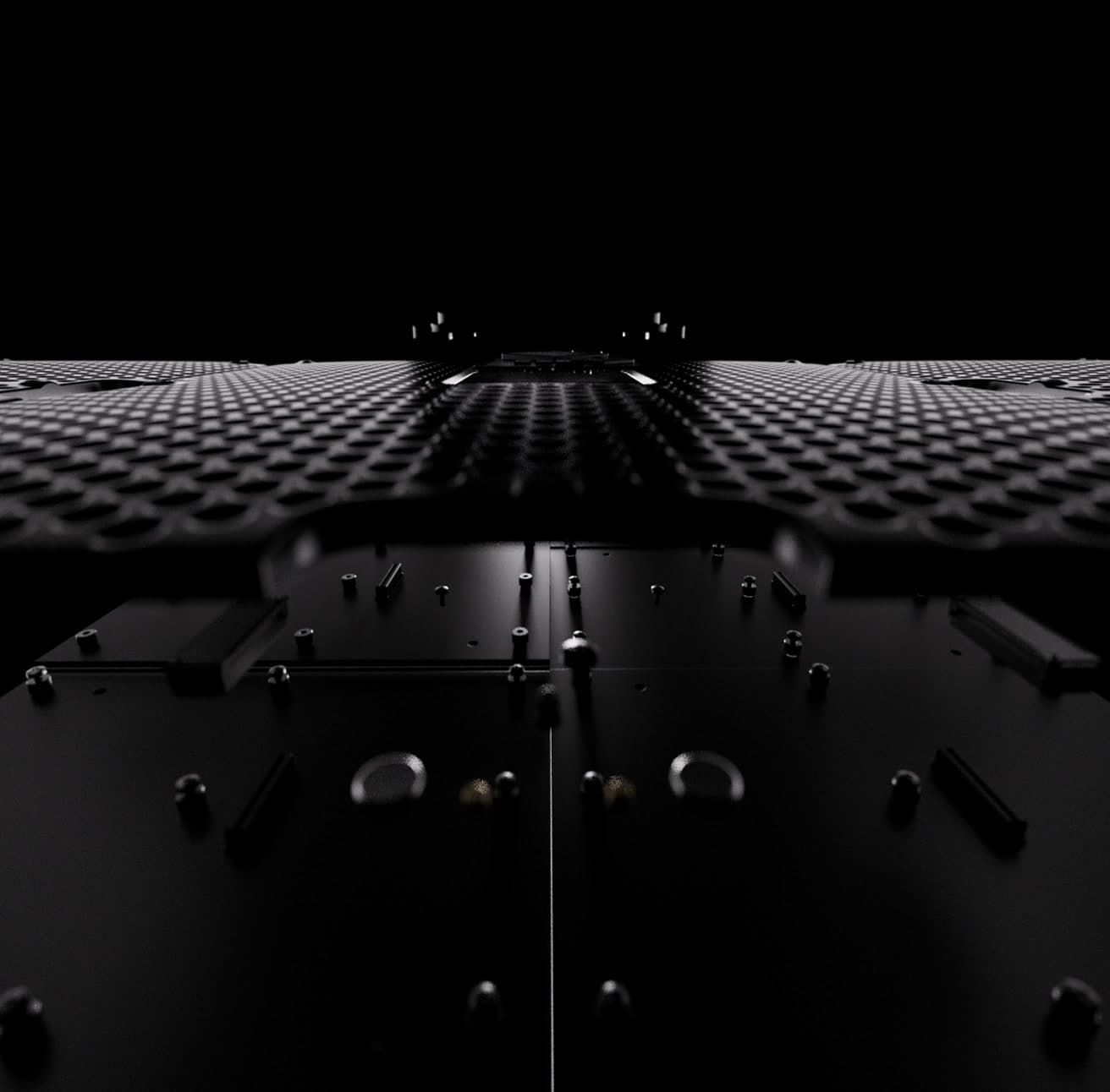 Left: dramatic low-angle macro of a black LED panel’s textured surface receding into darkness. (1 of 2)
