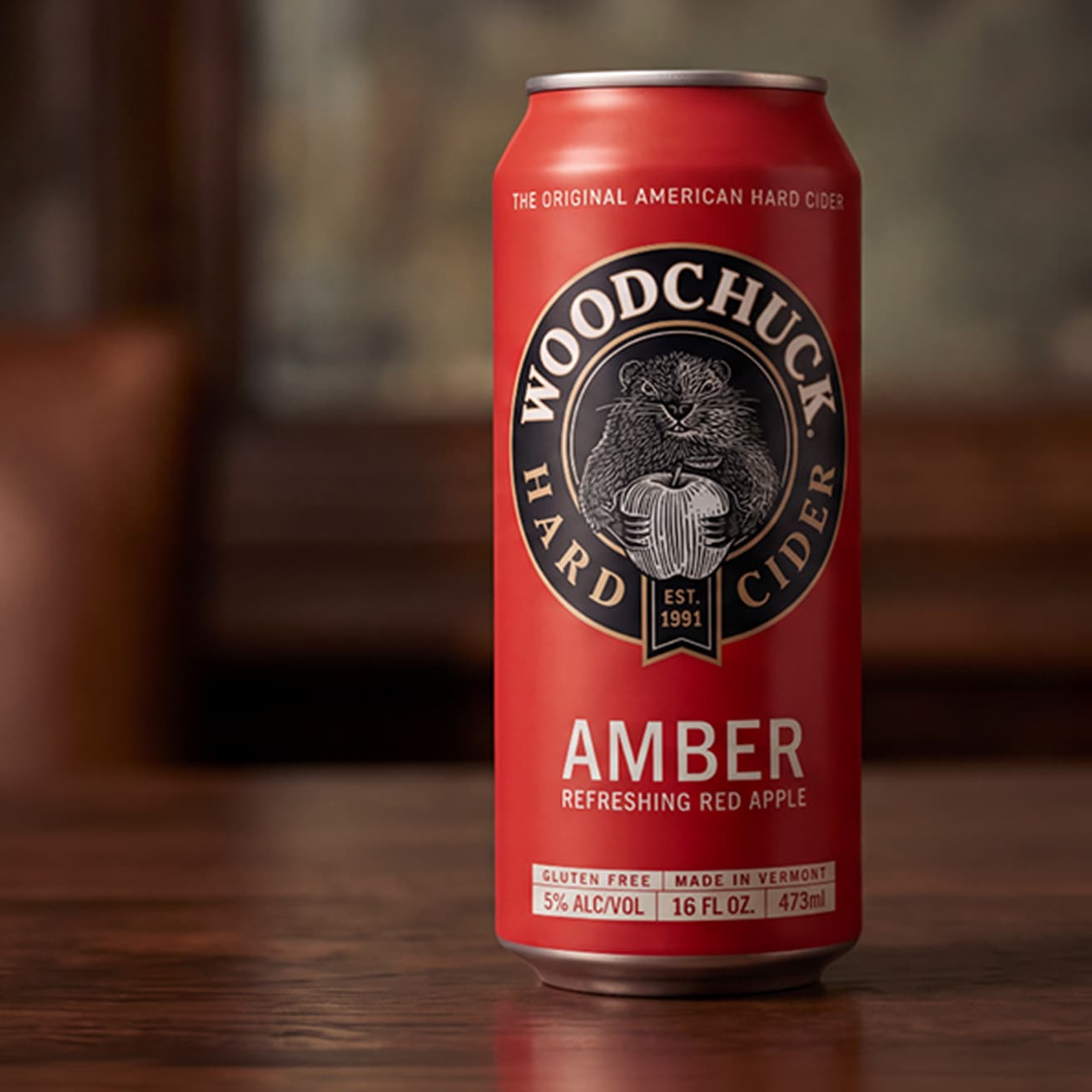 Red Woodchuck Amber 16oz can with the roundel logo on a wooden table (1 of 2)
