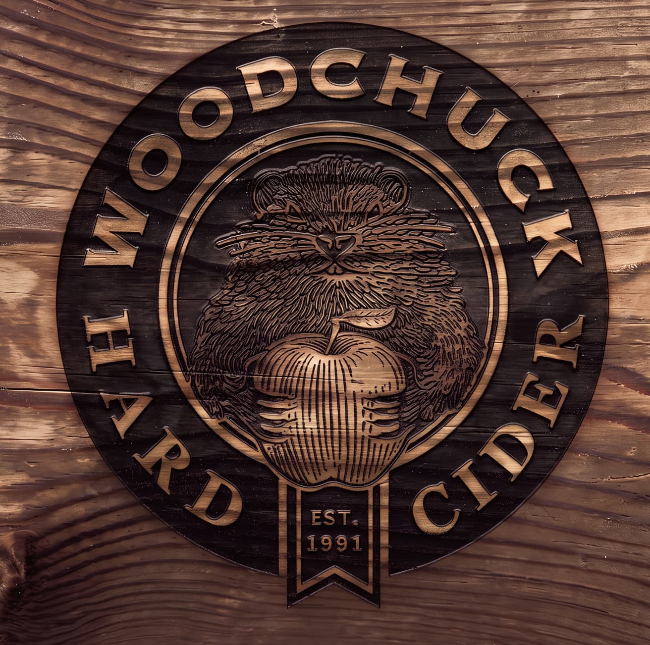 Woodchuck roundel logo carved and inlaid into weathered wood grain (2 of 2)